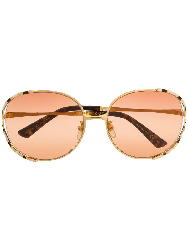 Gucci Eyewear Lunettes De Soleil à Monture Ronde Rayée 003 GOLD GOLD ORANGE 1 Gucci Eyewear Lunettes De Soleil à Monture Ronde Rayée 003 GOLD GOLD ORANGE